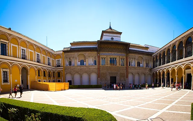 Der Patio de la Montería und die Fassade des Palastes Peters I. unter klarem blauem Himmel